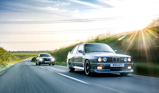 Two BMW M cars on the road