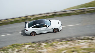 A white BMW M on the road