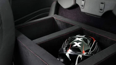A leather wrapped box is mounted in the rear for helmets