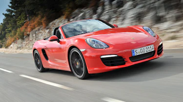 Porsche Boxster S driving, red with black wheels