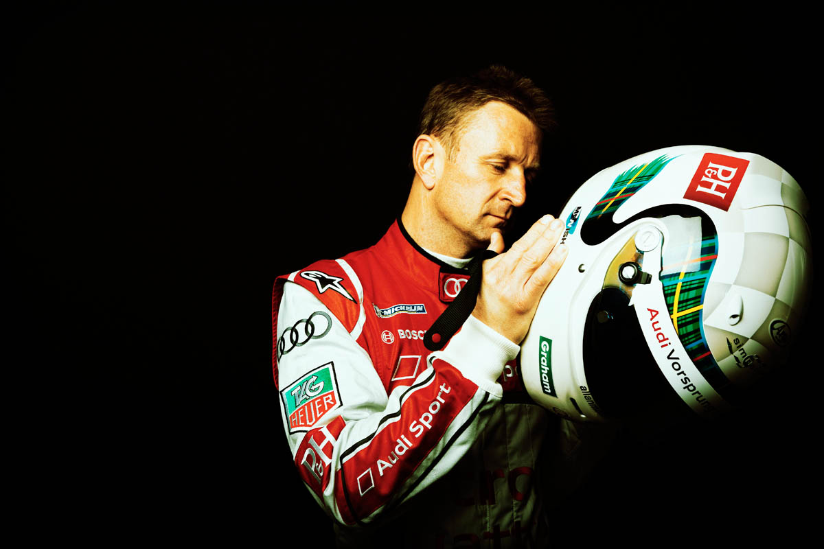 Allan McNish putting on his helmet