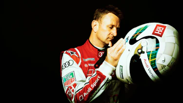 Allan McNish putting on his helmet