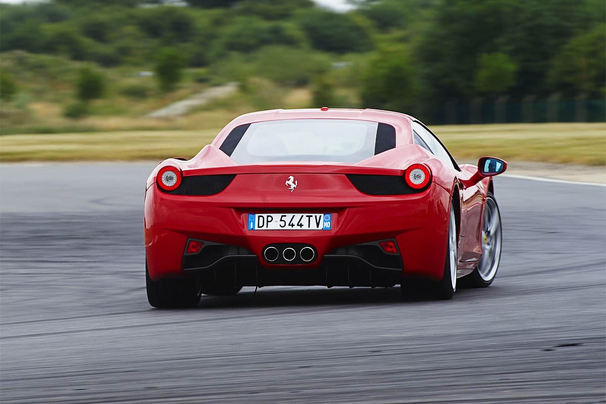Red Ferrari 458 Italia sliding on track