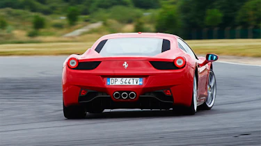 Red Ferrari 458 Italia sliding on track