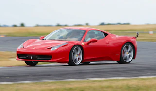 Red Ferrari 458 Italia sliding on track