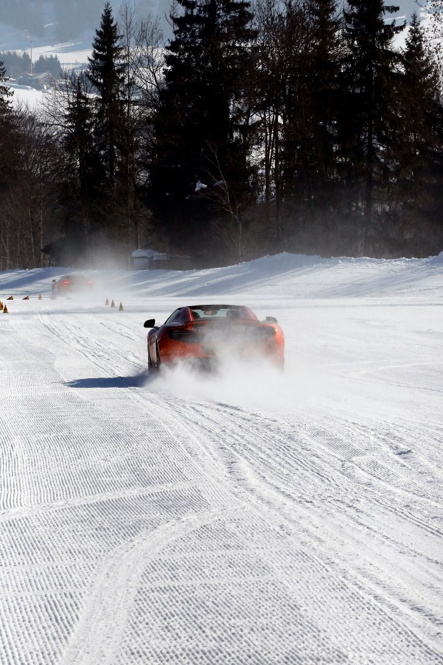 McLaren MP4-12C orange driving on snow