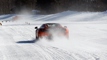 McLaren MP4-12C orange driving on snow