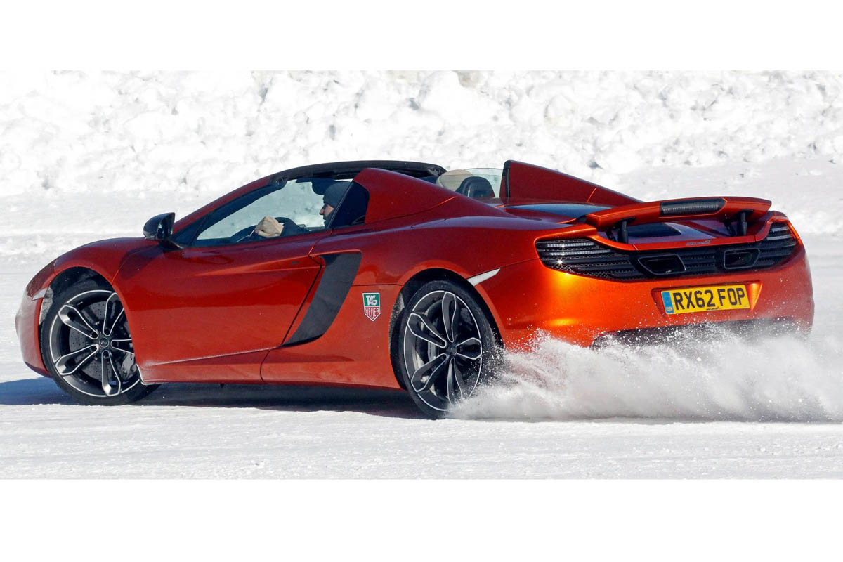 McLaren MP4-12C Spider roof down orange on snow