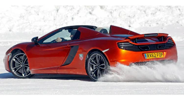McLaren MP4-12C Spider roof down orange on snow