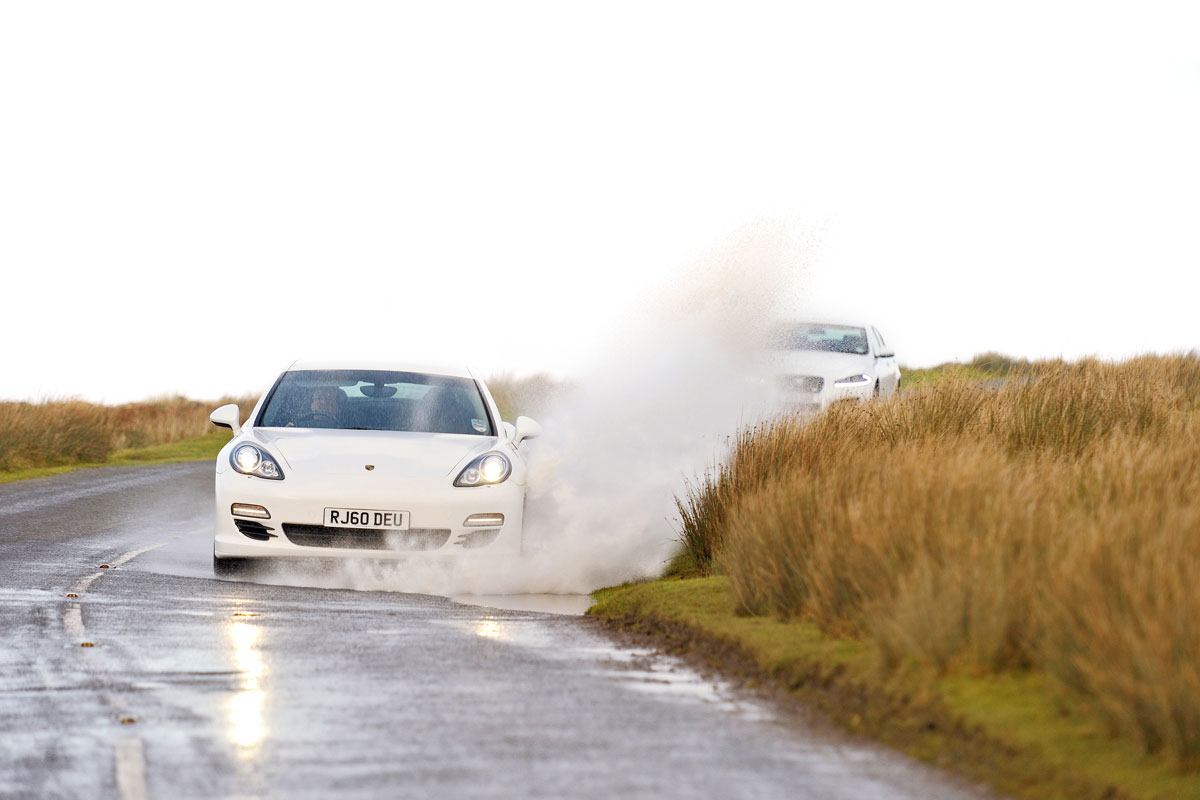 Porsche Panamera white, front driving water splash