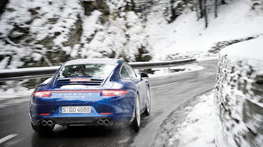 Porsche 911 Carrera 4S rear cornering shot in the snow