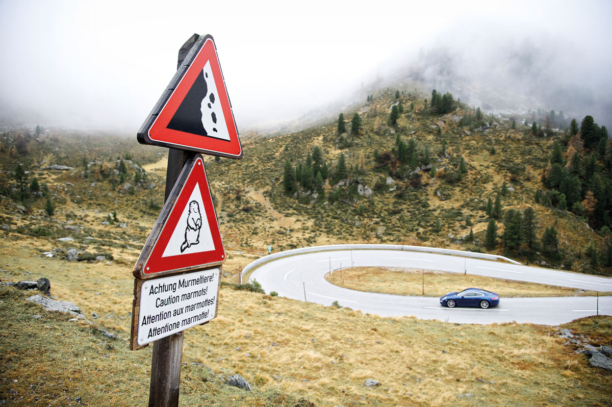 Porsche 911 Carrera 4S approaching a hairpin