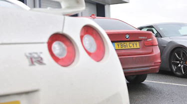 BMW 320d rear badge, with Nissan GT-R at Bedford Autodrome
