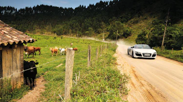 Audi R8 V10 Spider driving on dirt road