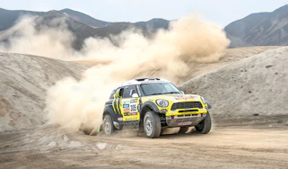 Mini riding the sand dunes on the Dakar rally