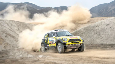 Mini riding the sand dunes on the Dakar rally