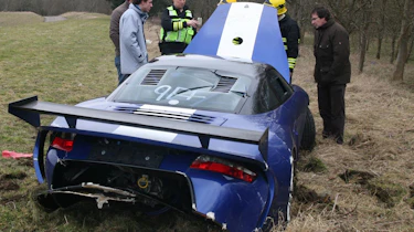 crashed 9ff GT9R with blokes by bonnet