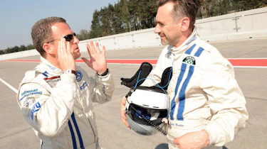 evo races an Audi R8 LMS at the Nurburgring 24 hours