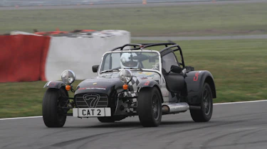 evo sprints a Caterham at Silverstone